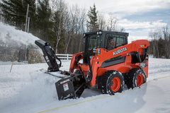 Kubota SSV75 skid steer with high-flow snow blower clearing a driveway
