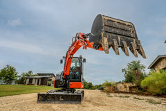 Kubota KX040-5 excavator lifting a toothed digging bucket at full height